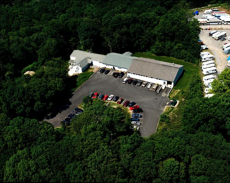 Aerial view of Able Coil's original facility, founded in 1969, with solar panels on roof