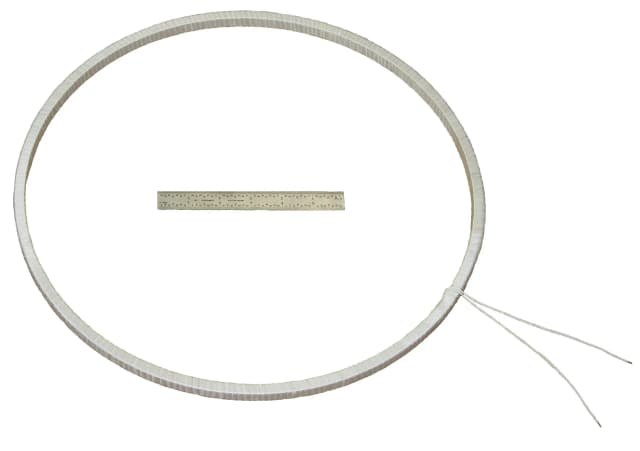 Large self-supporting coil next to a 1ft tape measure for size reference