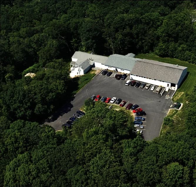 Aerial view of Able Coil's original facility, founded in 1969, with solar panels on roof